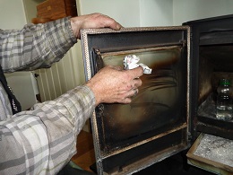 Cleaning wood burner glass scrubbing